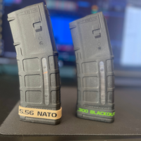 Thumbnail for Two rifle magazines with '5.56 NATO' and '300 Blackout' labels on a blurred background.